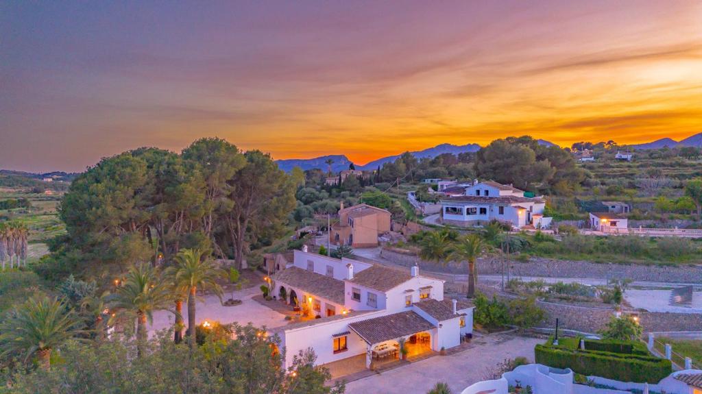 an aerial view of a house with a sunset at Villa Mas Blanc - PlusHolidays in Benissa