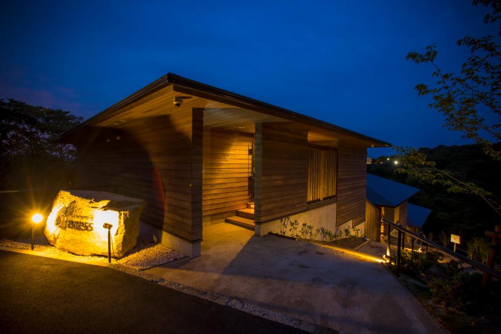a house with a light on the outside at night at Kisara Oneness in Toba