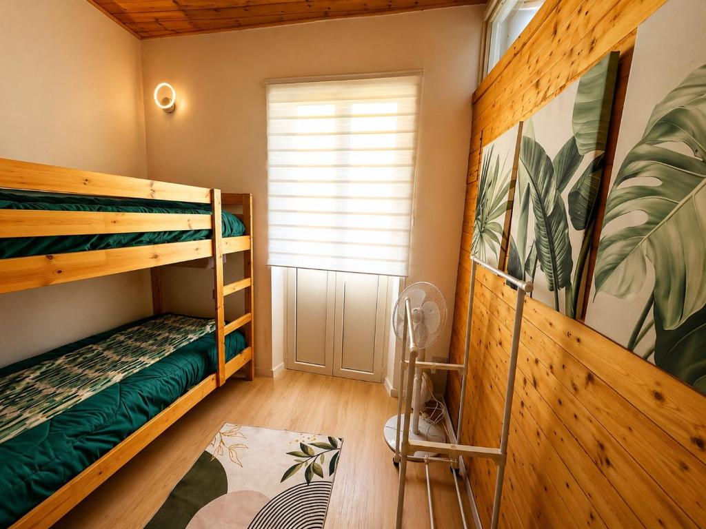 a room with two bunk beds and a window at Mediterranea Apartment in Agrigento