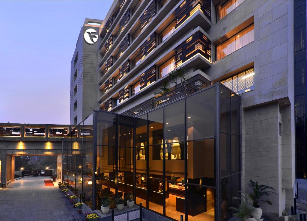 a large building with glass windows and a clock at Fortune District Centre, Ghaziabad - Member ITC's Hotel Group in Ghaziabad