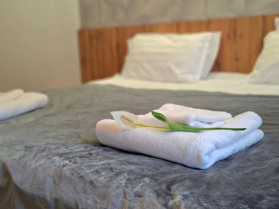 a pair of towels sitting on top of a bed at Hotel Mardin in Almaty
