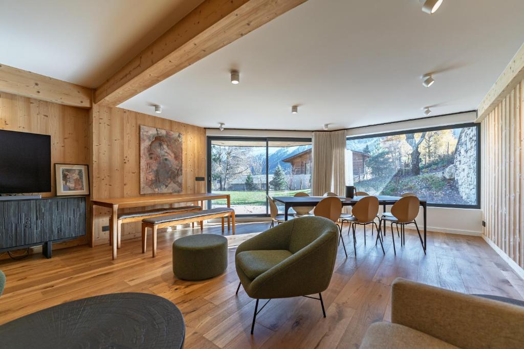a living room with a table and chairs at La Parenthèse du Goûter - by Care Concierge in Les Houches
