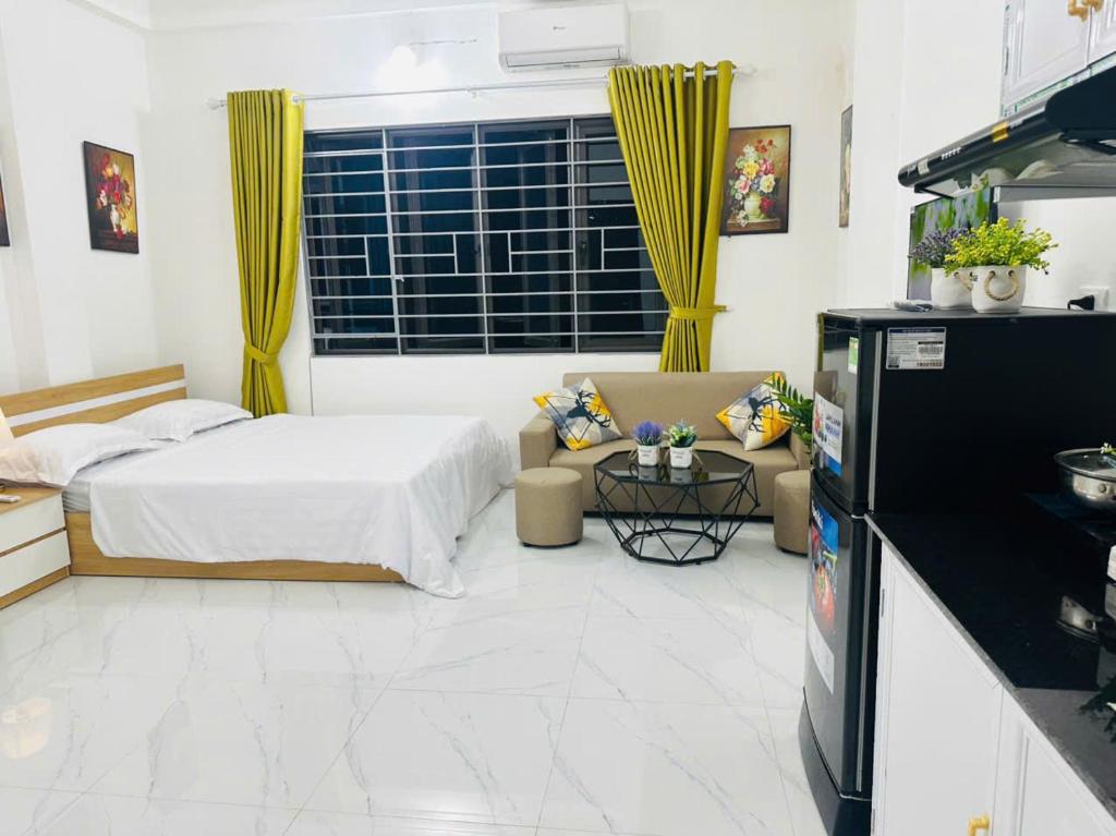 a living room with a bed and a couch at Harmony Apartment in Hanoi