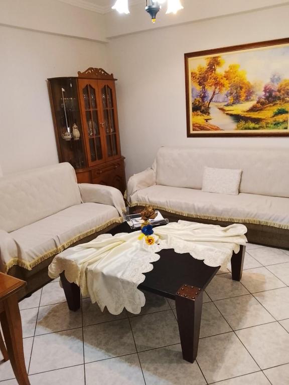 a living room with two couches and a coffee table at Savelona's Guest Appartment in Agrinio