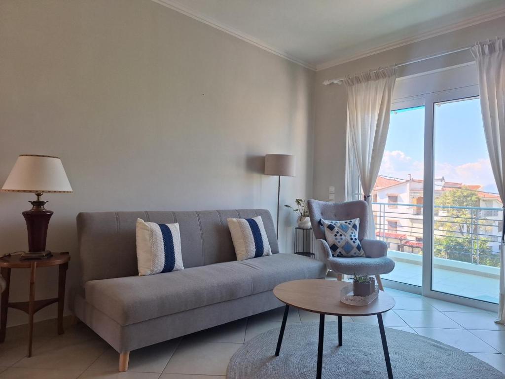 a living room with a couch and a window at Dimitra's APARTMENT NAFPLIO in Nafplio
