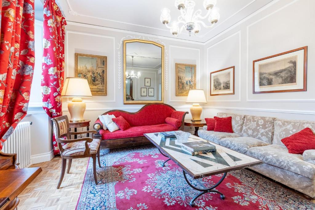 a living room with a couch and a table at GuestHost - Chic Central Apartment in Montecatini in Montecatini Terme