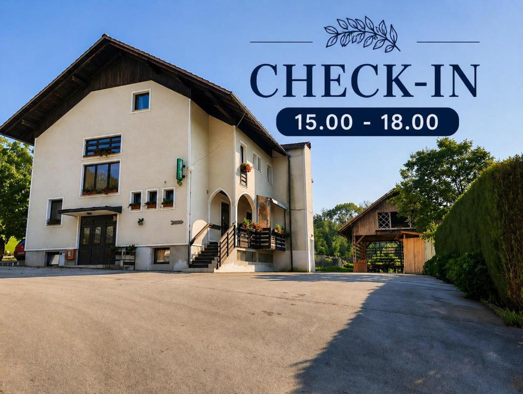 a building with a sign that reads check in at Tourist Farm Lavrič in Woditz