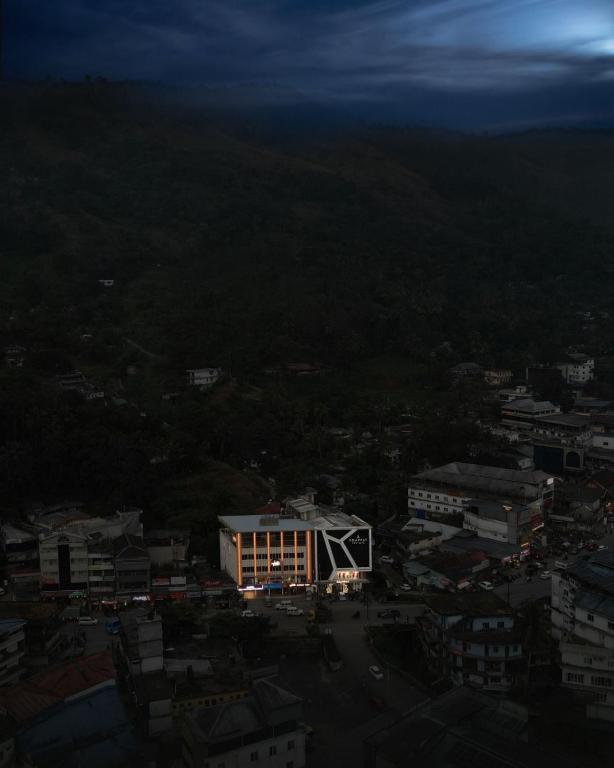 a lit up building in a city at night at Uphills boutique hotel in Kallar Vattiyar