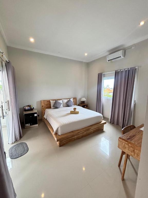 a bedroom with a large bed in a room at D'A HOUSE in Amed