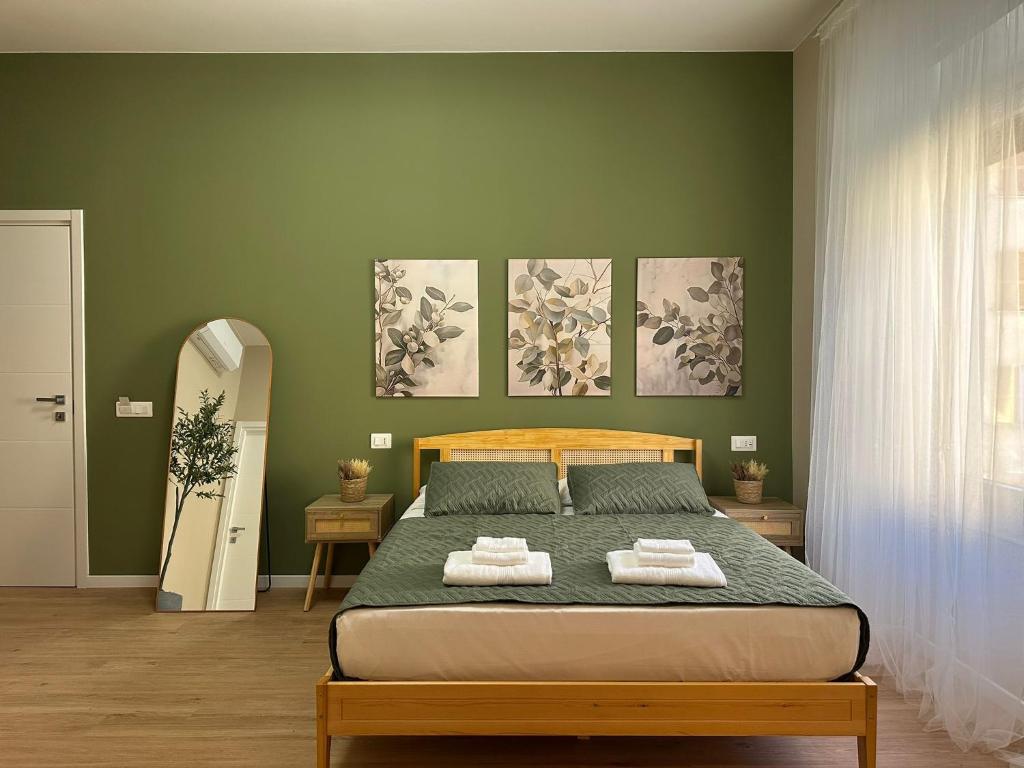 a bedroom with a bed with two towels on it at Affittacamere Yara 5 Terre in La Spezia