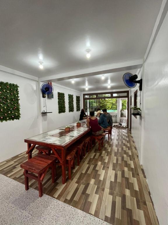 a group of people sitting at a table in a room at Ann's Place in Cabangan