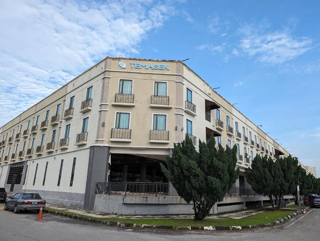 a large building with a car parked in front of it at HP Temasek Hotel in Malacca
