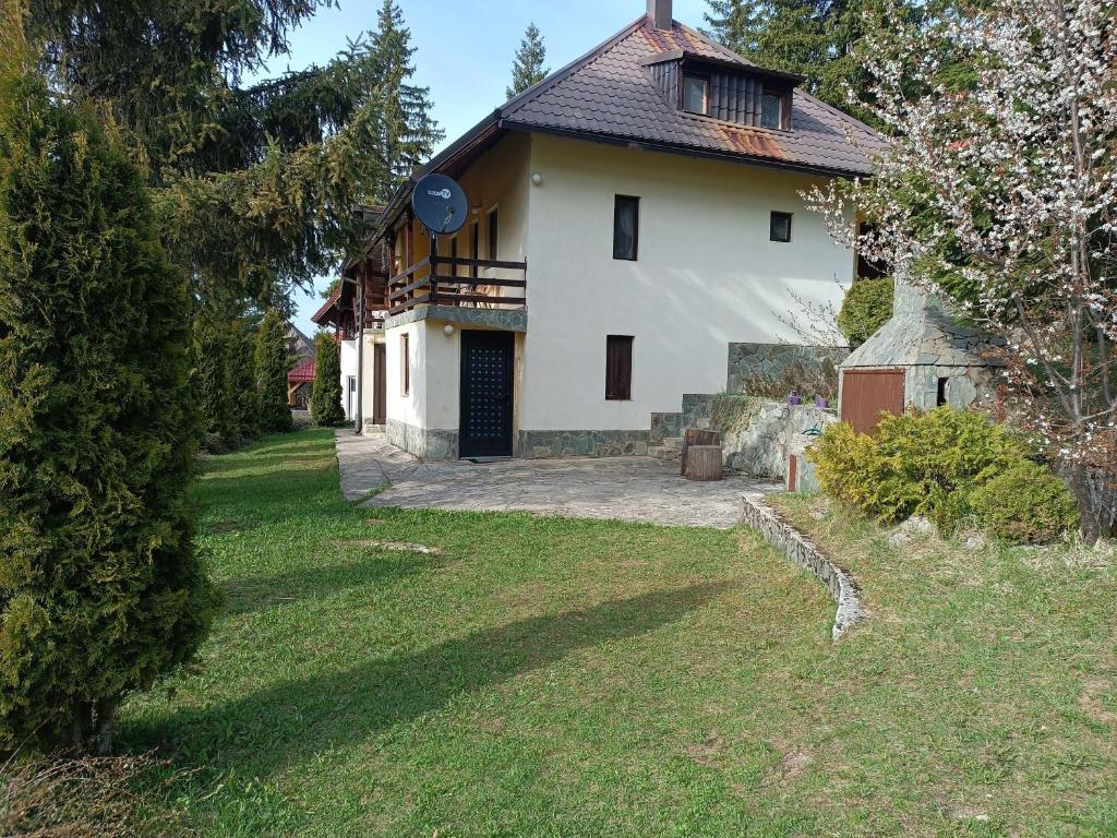 a large white house with a large yard at Vlasic Relax in Vlasic