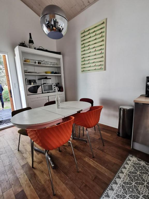 a kitchen with a table and chairs in a room at Chalet spacieux proche mer in Longeville-sur-Mer