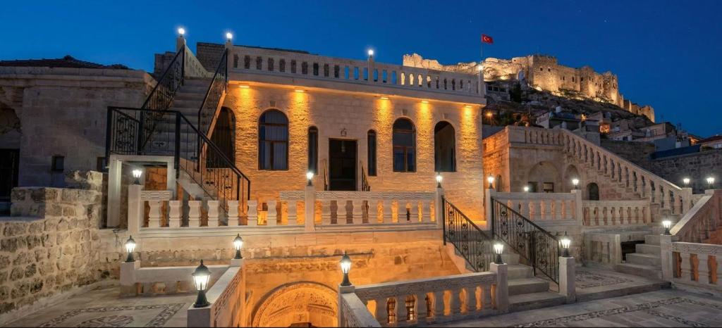 a building with stairs in front of a castle at Kasrı Hatun Konağı in Mardin