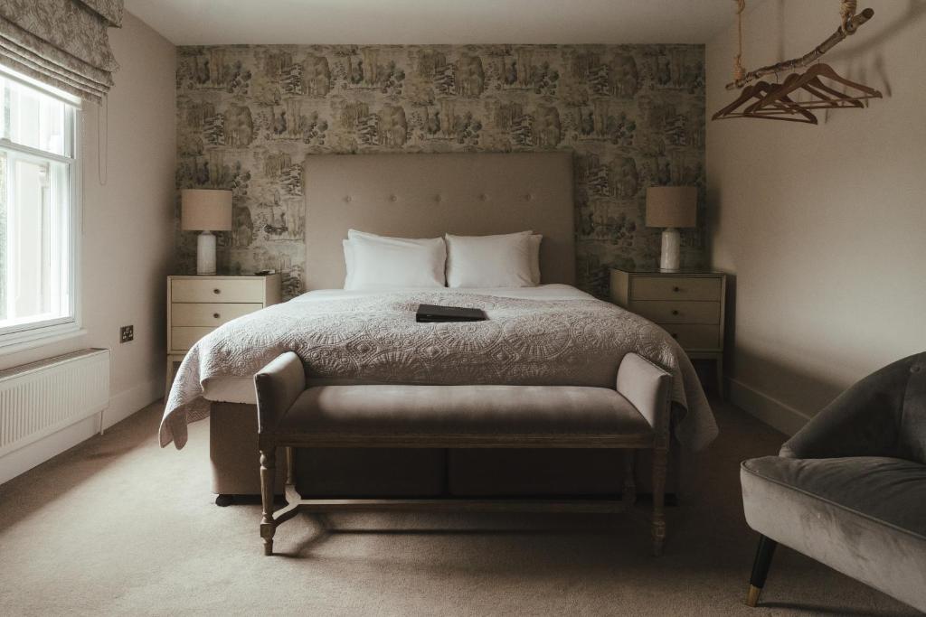 a bedroom with a bed and a chair in it at Winemaker's Pub in Goudhurst