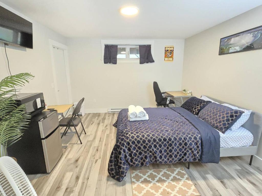 a bedroom with a bed and a desk with chairs at Cozy Newly Built Room in Halifax