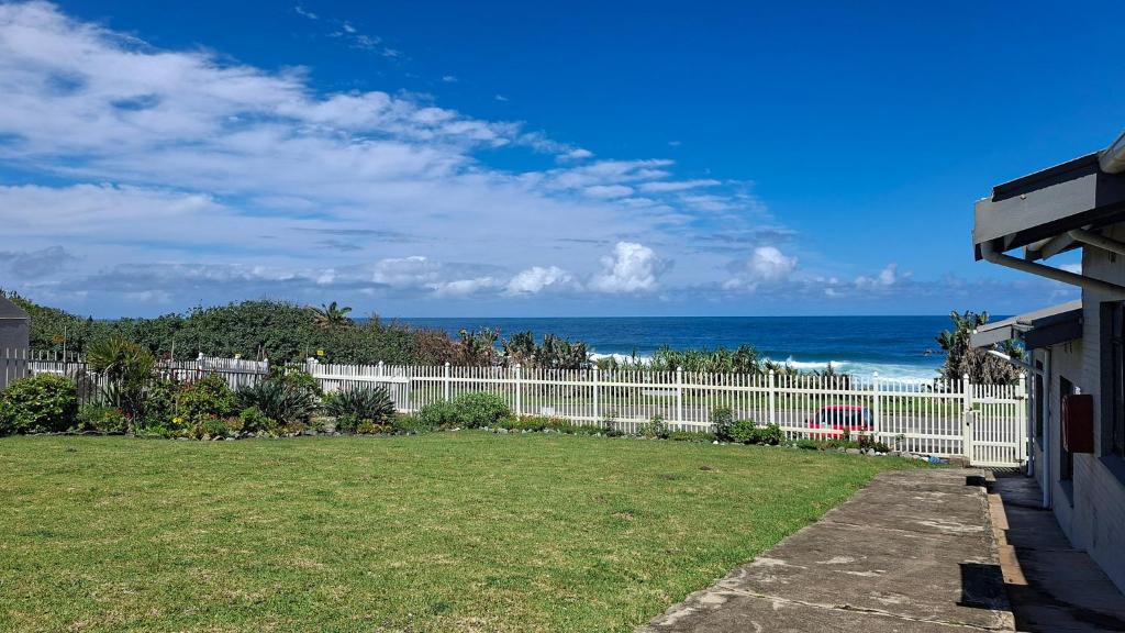 a white fence with the ocean in the background at Sue Casa 3 in Margate