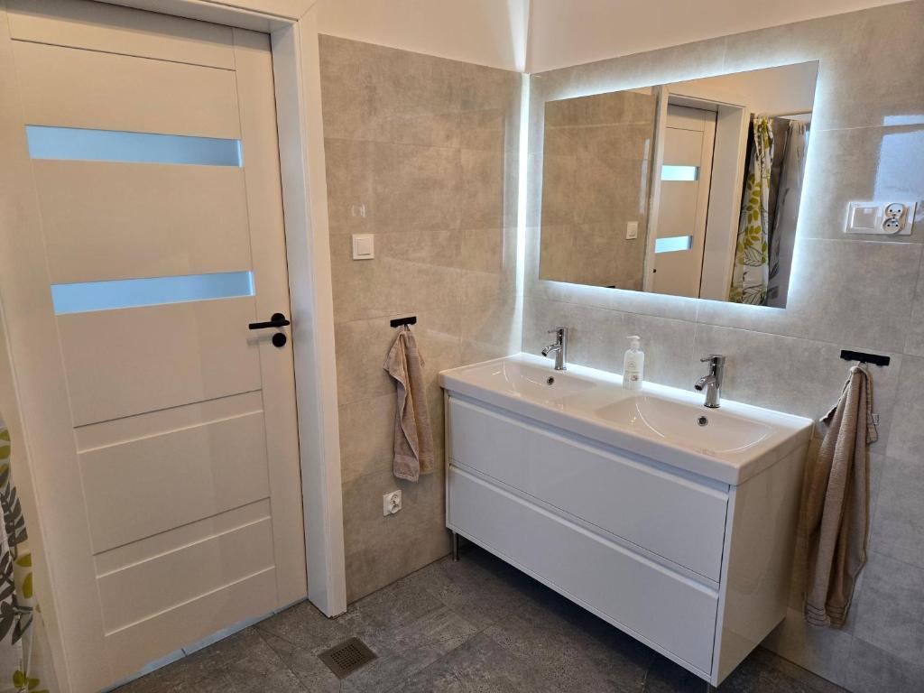 a bathroom with a sink and a mirror at KWT Hostel Nowogard - Self Check-In - Wejscie na KOD in Nowogard