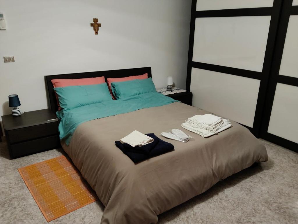 a bedroom with a large bed with two towels on it at Casa Jesus - suite home in Almese