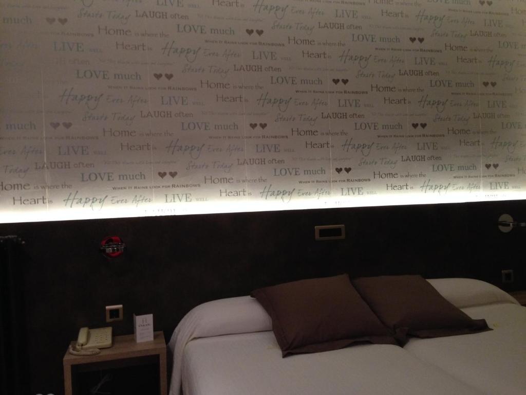 Postel nebo postele na pokoji v ubytování Hotel Oriente