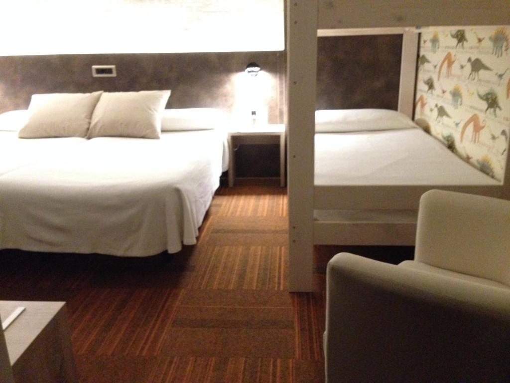 Postel nebo postele na pokoji v ubytování Hotel Oriente