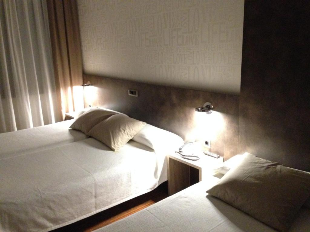 Postel nebo postele na pokoji v ubytování Hotel Oriente