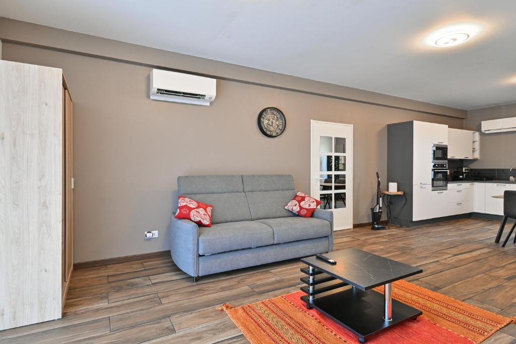 a living room with a couch and a table at Studio 42m² Design in Annecy