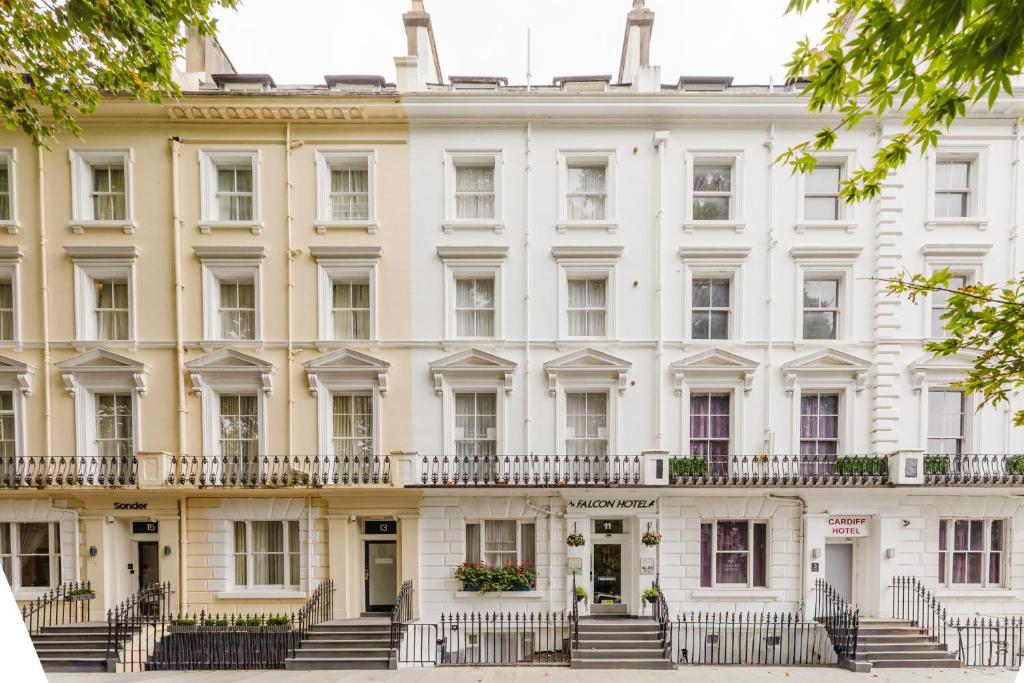 a large white building with stairs in front of it at Falcon Hotel in London
