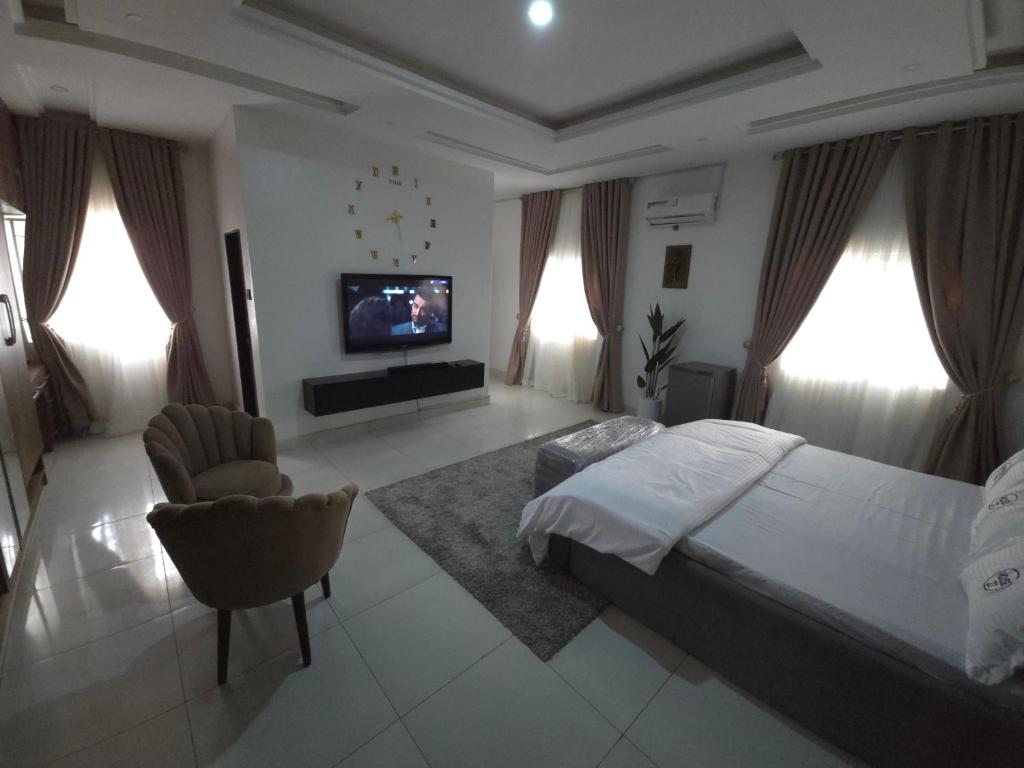 a bedroom with a large bed and a television in it at House 27 Alpha in Idu