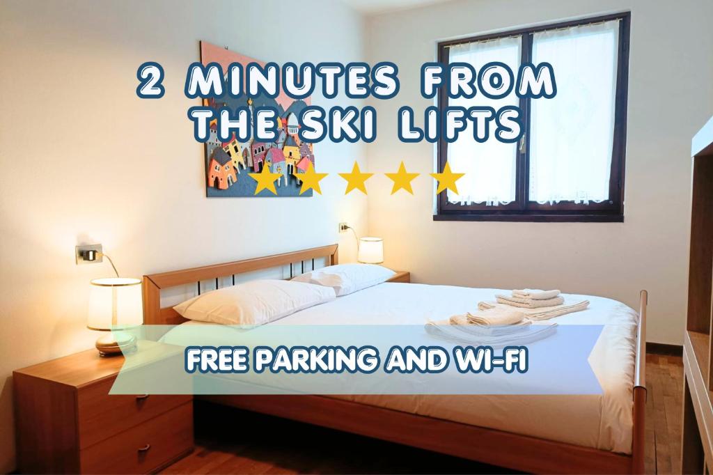 a bedroom with a bed with the words minutes from the sun lights at Mountain Haven Free parking in Temù