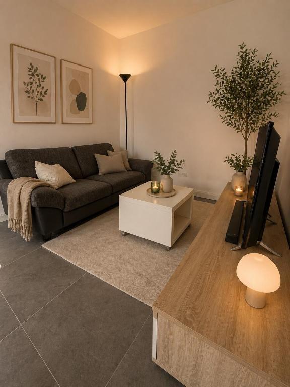 a living room with a couch and a table at Lux Apartments in Lichtenfels