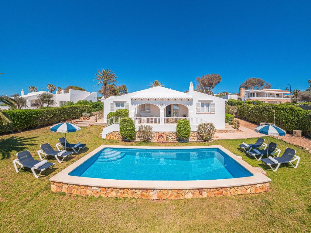 a house with a swimming pool in the yard at Villa BiniRe by 3VILLAS in Binibeca