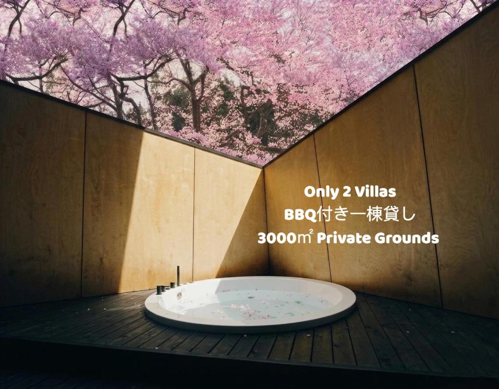 a bath tub in a room with a tree at Kokage Villa Nikko-KVN in Nikko