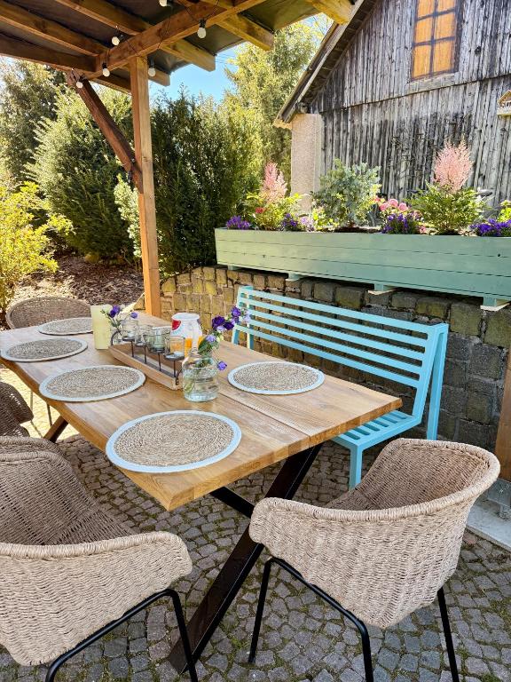 a wooden table and chairs on a patio at Apartmán U Mluvících Kamenů in Staré Křečany