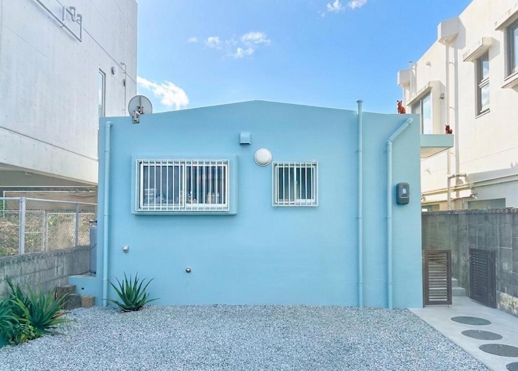 a blue door with a window on a building at AQUAMARINE HOTEL Nagahama in Nagahama