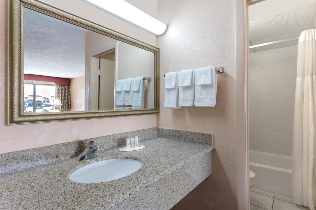 a bathroom with a sink and a mirror at Quality Inn Waycross in Waycross