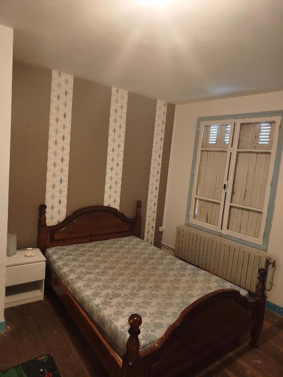 a bedroom with a bed and a window at Chambre pèlerinage in Saint-Hilaire-la-Palud