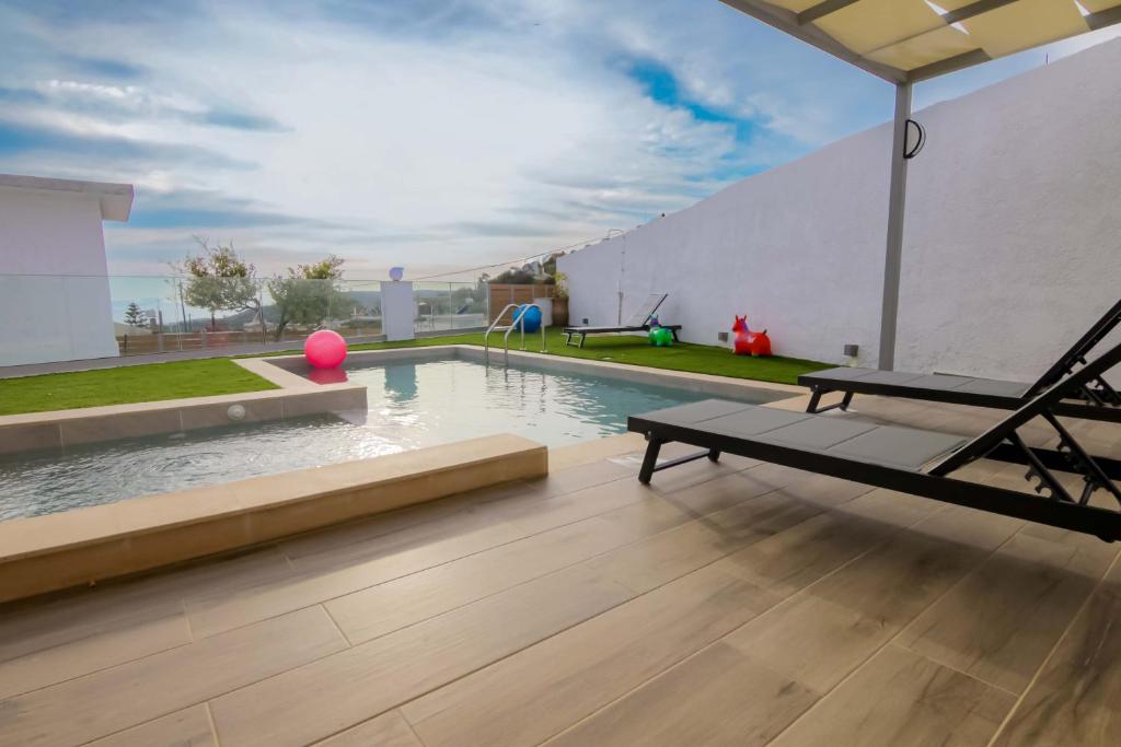 a swimming pool with a hammock in a house at Thea Villa in Kokkinos Pirgos