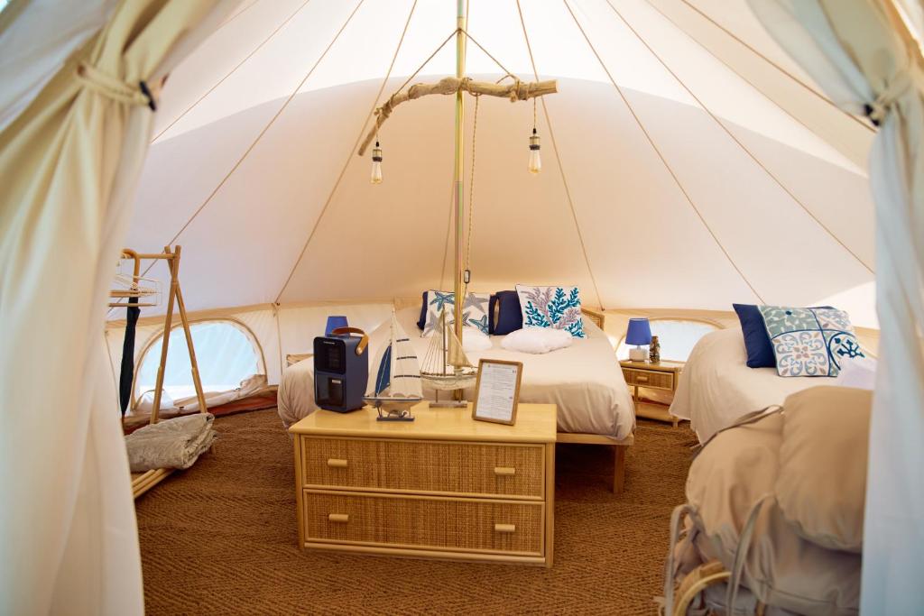 a room with two beds in a tent at I Giardini del Caramante in Soverato Marina