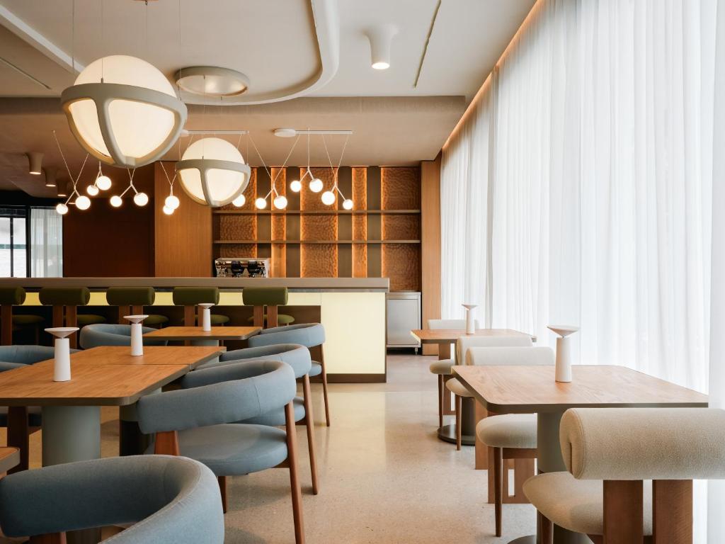 a restaurant with tables and chairs and a bar at Boutique Hotel Venturo, a Member of Design Hotels in Split