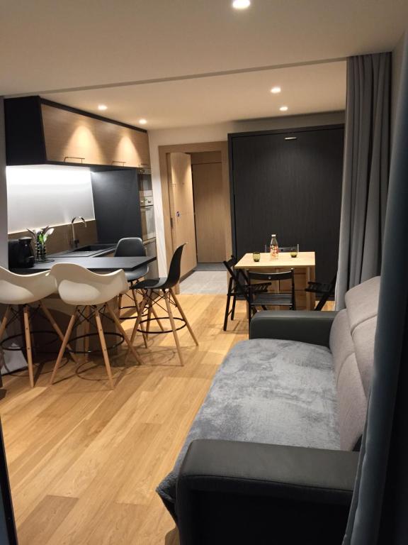 a living room with a couch and a table at Studio proche pistes Chantemerle in Saint-Chaffrey