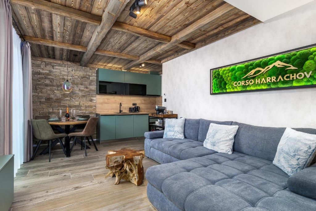 a living room with a couch and a table at Mountain Apartment No 209-CORSO Harrachov, High Speed WI-FI, Ambilight smart TV, Netflix, YouTube, FREE parking, private SEJF, PRIVATE bike storage, HARRACHOVCARD in Harrachov