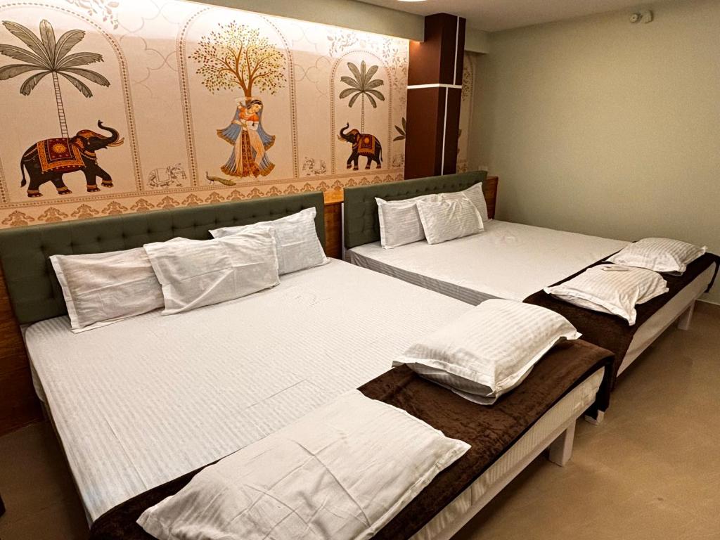 a group of beds in a room at ADITI ROOMS in Tiruchirappalli
