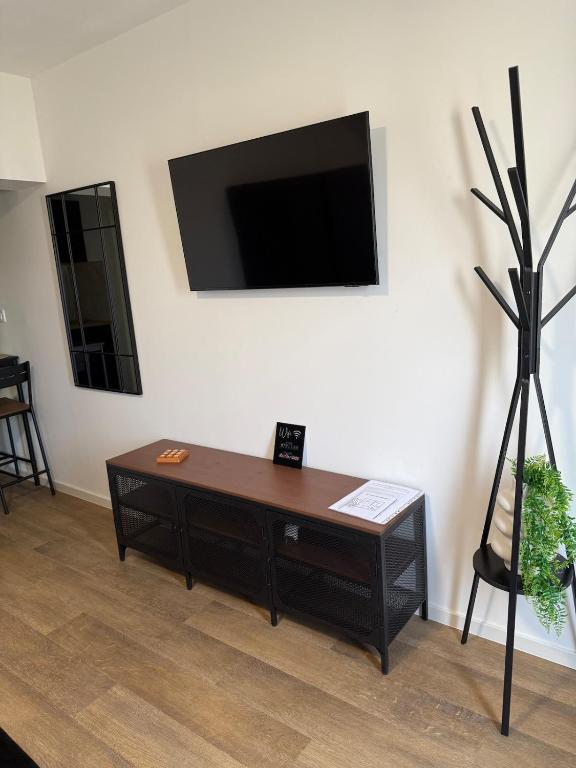 a living room with a coffee table and a flat screen tv at Studio apartman StelLar in Otavice