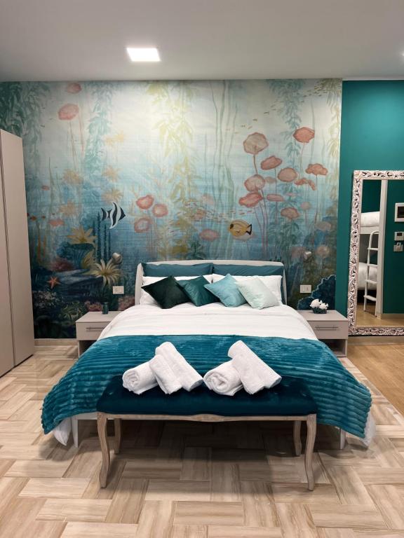 a bedroom with a bed with towels on it at Da Delfina Affittacamere in Anzio