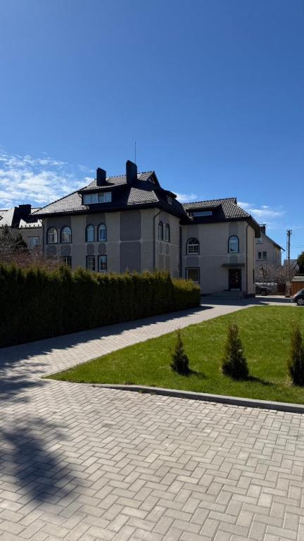 a house with a brick driveway in front of a house at DelMar in Klaipėda