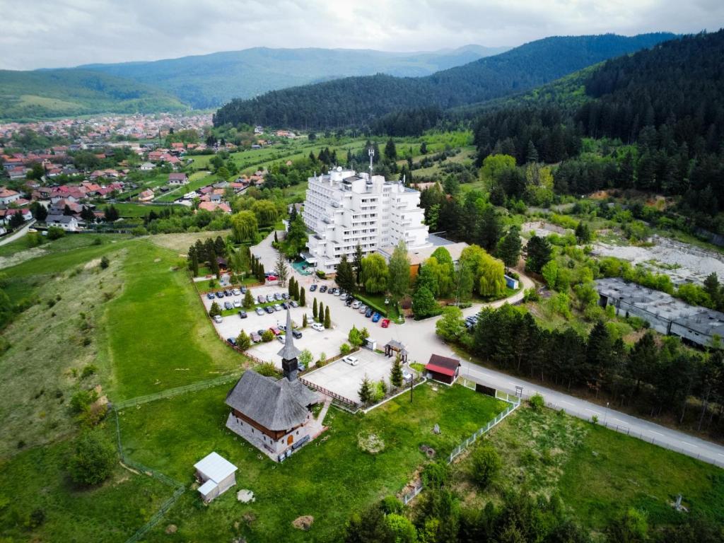 an aerial view of a building on a green field at Hotel Montana - Covasna in Covasna
