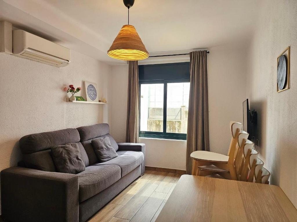a living room with a couch and a table at Apartments Sant Lluis CENTER, 2 min walk from the sea in Lloret de Mar