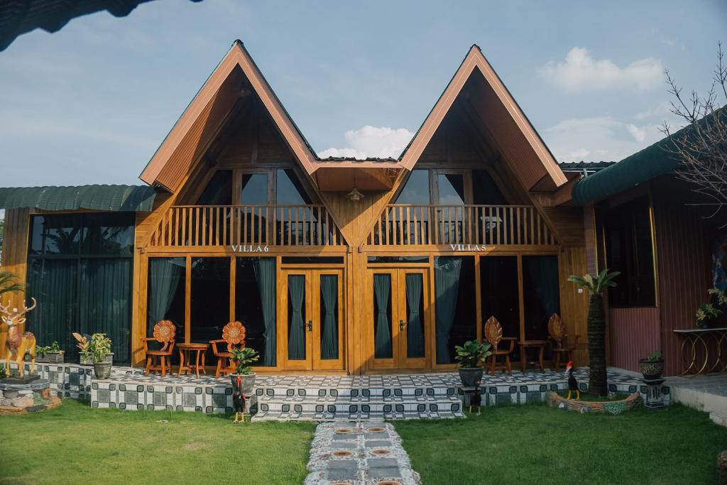 a house with windows and chairs in the yard at MIK Resort & Hotel in Pasuruan